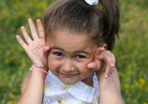 Girl playing on wild flower meadow